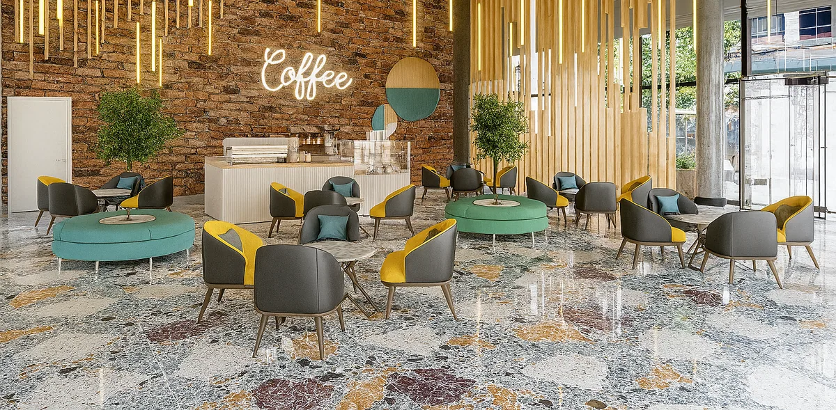 Polished floor with large multicoloured stone pieces beneath café seating, green benches and a brick feature wall.